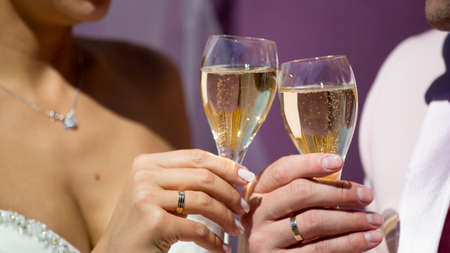 Couple, man and woman, drinking champagne in a fine dining restaurant, each with glass of sparkling wineの写真素材
