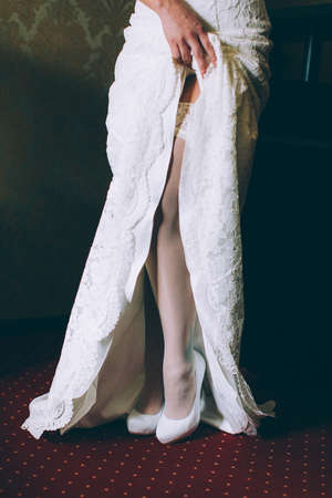 Hem of her dress. Bride shoes. Lace train wedding dress.の写真素材