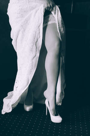 Hem of her dress. Bride shoes. Lace train wedding dress.の写真素材