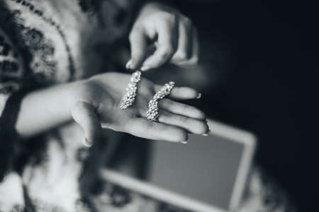 Bride is holding earringsの写真素材