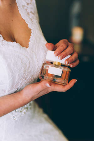 The bride holding in hands a bottle of perfumeの写真素材