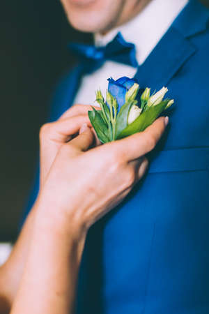 wedding boutonniere on suit of groom