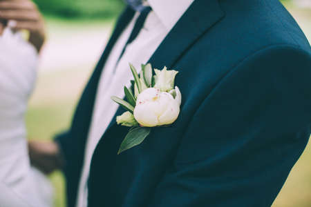 wedding boutonniere on suit of groomの写真素材