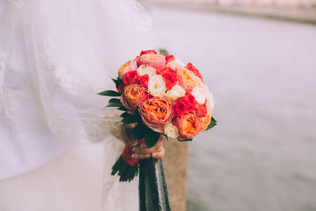 Beautiful wedding bouquet in hands of the brideの写真素材