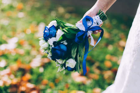 Beautiful wedding bouquet in hands of the brideの写真素材
