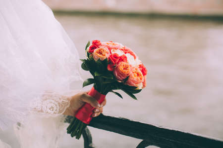 Beautiful wedding bouquet in hands of the brideの写真素材