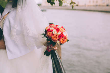 Beautiful wedding bouquet in hands of the brideの写真素材