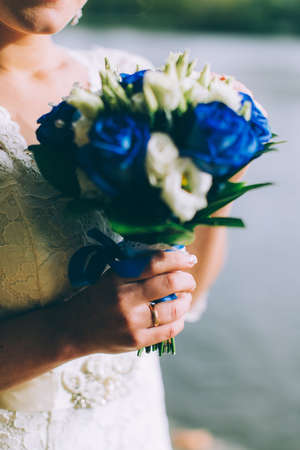 Beautiful wedding bouquet in hands of the brideの写真素材