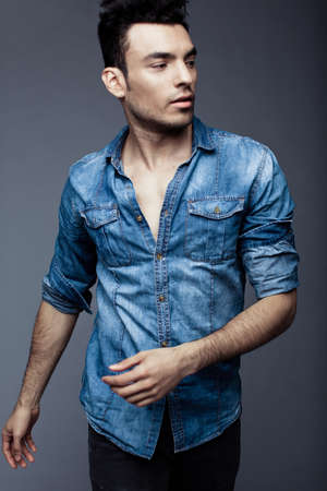 Portrait of handsome young man in casual denim clothes standingの写真素材