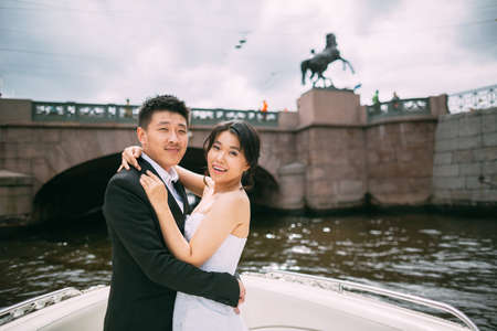 Bride and groom are floating on a boat on the city's rivers and canalsの写真素材