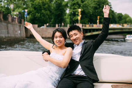 Bride and groom are floating on a boat on the city's rivers and canalsの写真素材