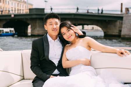 Bride and groom are floating on a boat on the city's rivers and canalsの写真素材