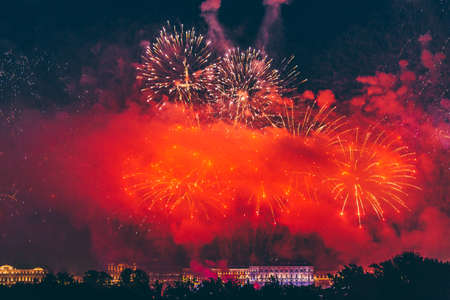 Fireworks over the city of St. Petersburg (Russia) on the feast of "Scarlet Sails", in the rain with fog and smoke.の写真素材