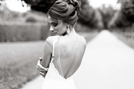 beautiful young bride standing in a parkの写真素材