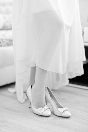 Bride dresses shoes before the wedding ceremonyの写真素材