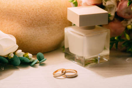 pair of gold wedding rings with beauty backgroundの写真素材