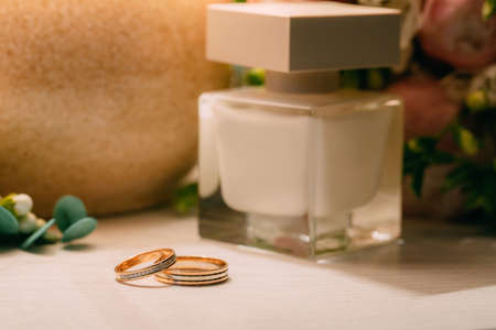 pair of gold wedding rings with beauty backgroundの写真素材