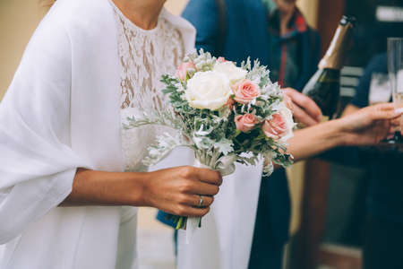 Beautiful wedding bouquet in hands of the brideの写真素材