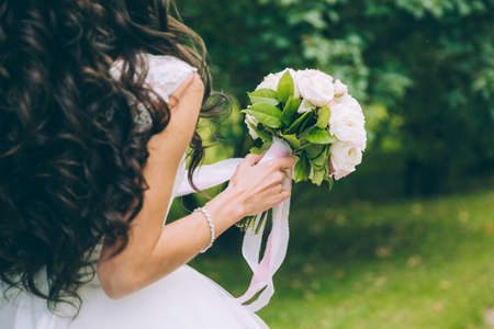 Beautiful wedding bouquet in hands of the brideの写真素材