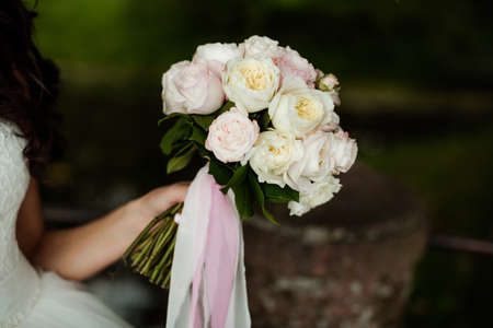 Beautiful wedding bouquet in hands of the brideの写真素材
