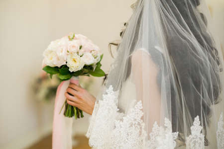 Beautiful wedding bouquet in hands of the brideの写真素材