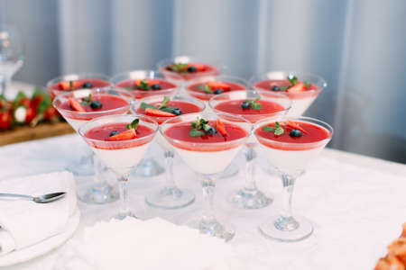 Wedding Party. Red cocktails in glasses ready for party people. Red cocktail at wedding reception.の写真素材