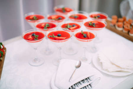 Wedding Party. Red cocktails in glasses ready for party people. Red cocktail at wedding reception.の写真素材