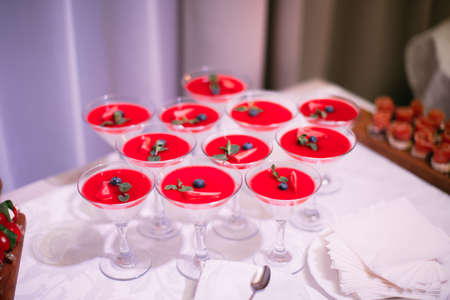 Wedding Party. Red cocktails in glasses ready for party people. Red cocktail at wedding reception.の写真素材