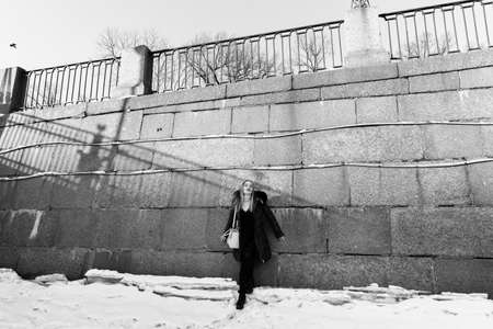 Picture of a girl against a background of snow and the cityの写真素材