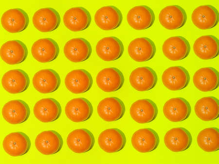 Colorful fruit pattern of fresh mandarins on a light green background. Top viewの写真素材