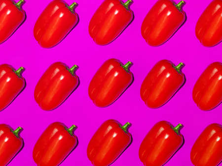 Colorful pattern of fresh pepper on a purple background. Top view