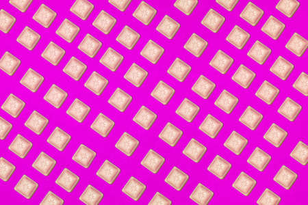 Colorful pattern of chocolate slices on a purple background. Top viewの写真素材