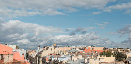 Sunset view at the Isaak Cathedral from the roof of Saint-Petersburg city. Ancient roof of the city. Old historical city. Amazing sunset at the top of the cityの写真素材