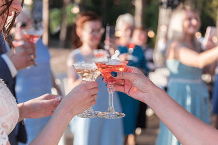 Cropped photo of many people hanging out clink glasses with champagne