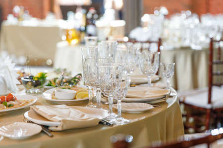 Table setting, glasses on table in restaurantの写真素材