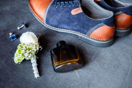 Blue cufflinks, boutonniere, toilet water and groom's shoesの写真素材