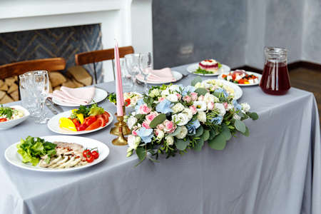 Table decorations for holidays and wedding dinner. Table set for holiday, event, party or wedding reception in outdoor restaurantの写真素材