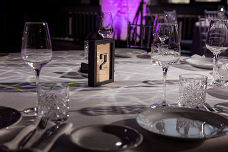 stylish empty glasses and plates at setting at elegant table for wedding reception, catering in restaurantの写真素材
