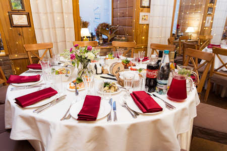 beautifully set tables with glasses and appliances for a wedding or other eventの写真素材