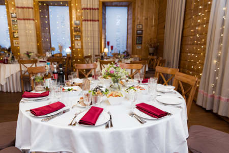 beautifully set tables with glasses and appliances for a wedding or other eventの写真素材