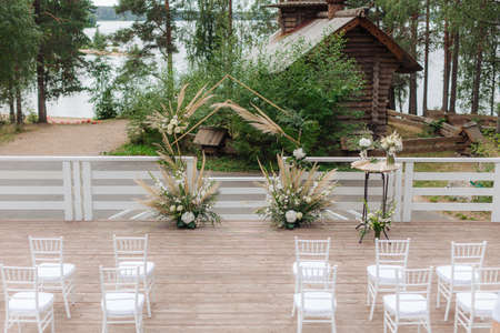 Beautiful wedding arch on the background of the lake and the old churchの写真素材