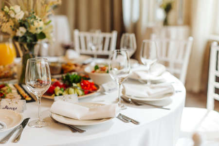 beautifully set tables with glasses and appliances for a wedding or other eventの写真素材