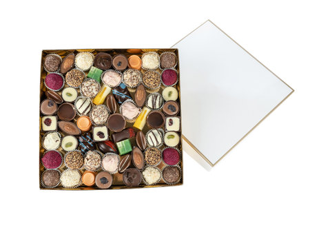 handmade chocolates in a cardboard box with a lid on a white backgroundの写真素材