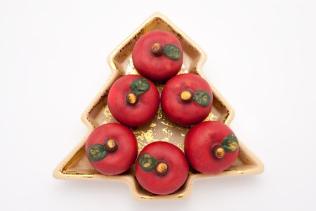 fir tree shaped china dish with red clay applesの写真素材