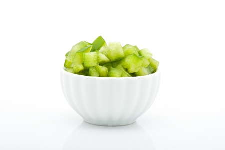 closeup of fresh green peppers in bowl isolated on white background の写真素材
