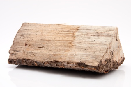 closeup of one single piece of firewood isolated on white backgroundの写真素材