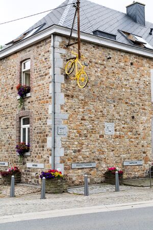 HENRI-CHAPELLE, BELGIUM, 25th JUNE, 2017 - painted bike fixed on a house wallのeditorial素材