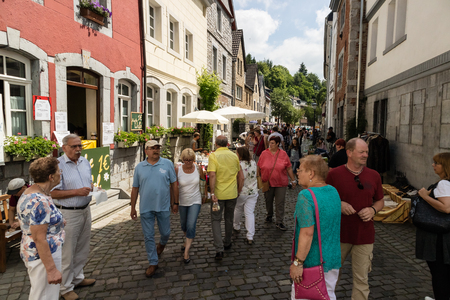 KORNELIMUENSTER, GERMANY, 18th June, 2017 - People browse the historic fair of Kornelimuenster on a sunny warm day. The fair is held annually in the historic old town of Kornelimuenster near Aachen for four days. It attracts a large number of people. Credのeditorial素材