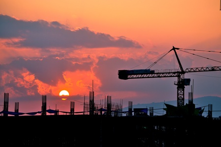 silhouette crane building and sunset of Southeast Asia