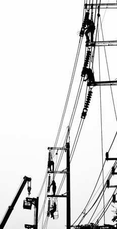 silhouette electrician working on electricity postの写真素材